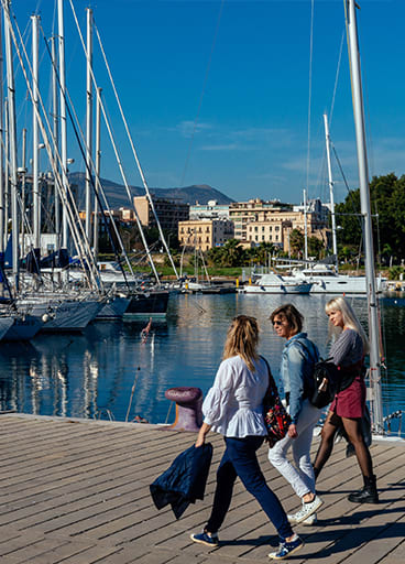 A group of tourists walking in the port of Palermo, Sicily