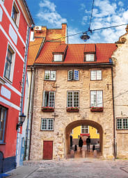 Two people walking through an alley in Riga, The Baltic States