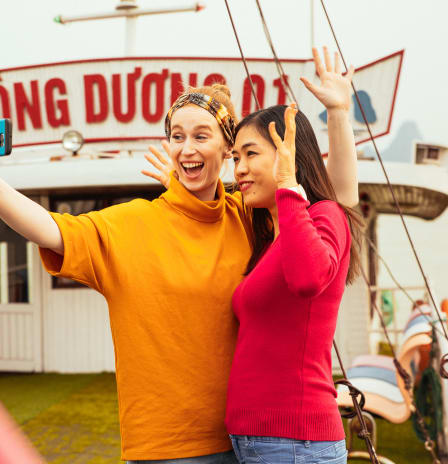 Two tourist on a boat in Halong Bay making a selfie