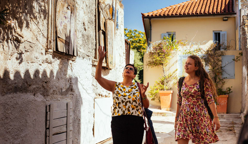 A local guide showing a tourists the non-touristic side of Athens