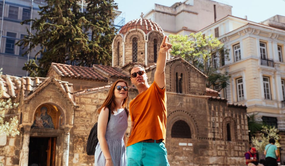 A local guide with a tourists at the streets of Monastiraki in Athens