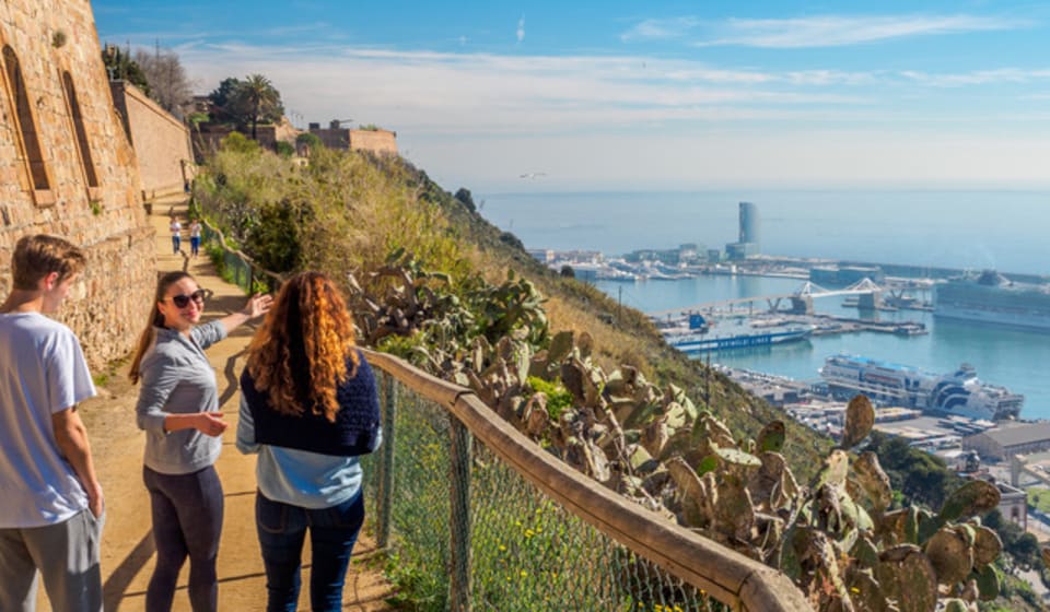 A local guide with some tourists wandering around at Montjuic hill in Barcelona