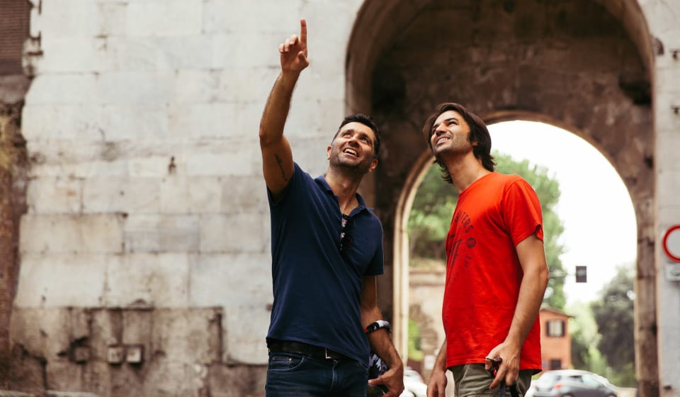 A local guide showing a tourist a highlight on the streets of Rome
