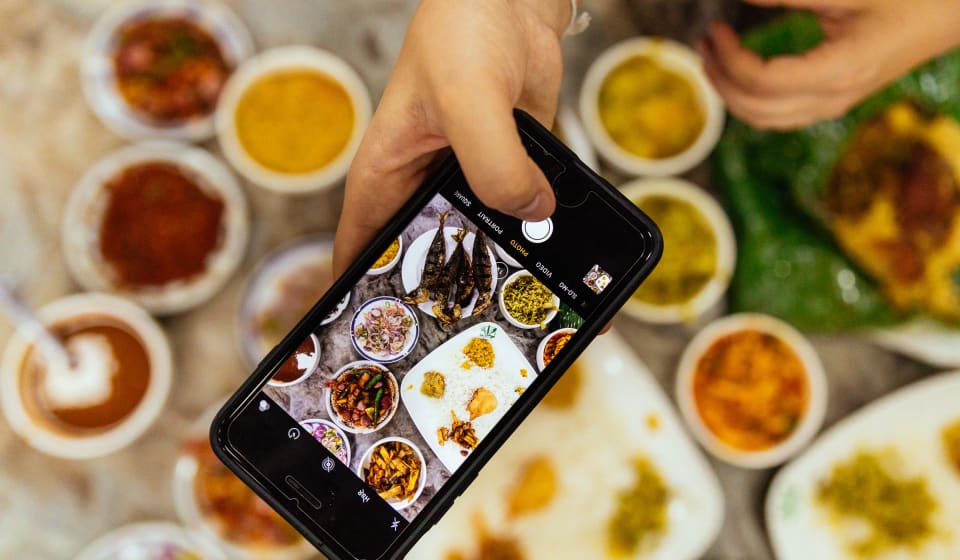 A top down view of a phone that is taking a picture of Sri Lankan food