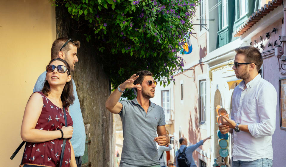 A local guide explaining a story to a group of tourists near Sintra