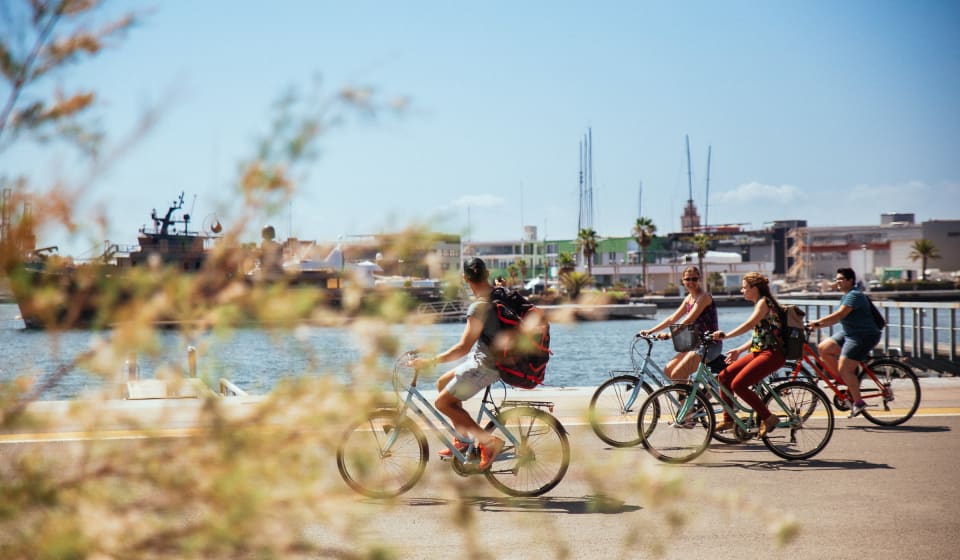 A group biking next to the river Turia
