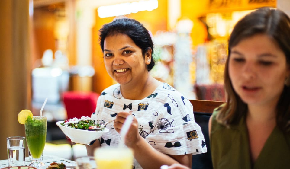 Two girls at a table eating