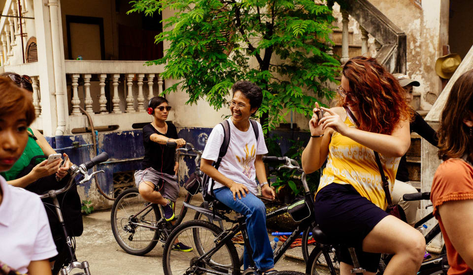 A tourist on a bike making a picture in the streets of Singapore