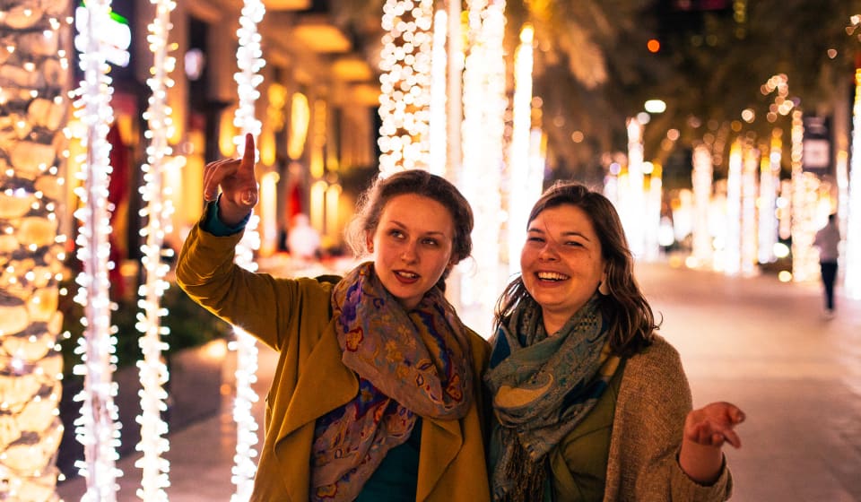 Two ladies on the streets of Abu Dhabi in the evening