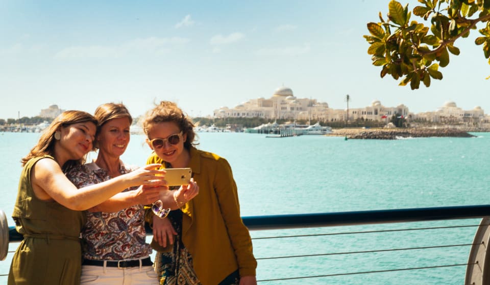 Three ladies taking a selfie at the waterfront in Abu Dhabi