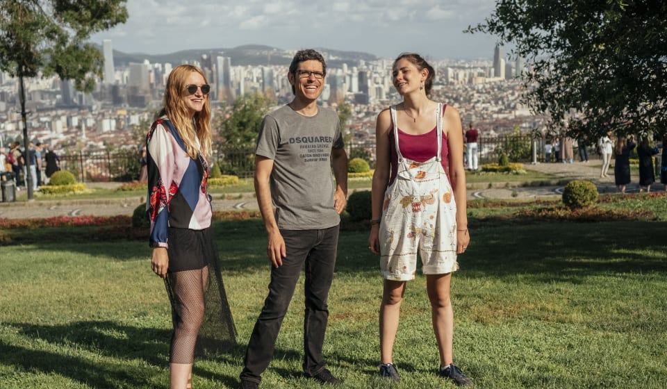 A local guide with two tourist on Anadolu Kavagi with a view on Istanbul