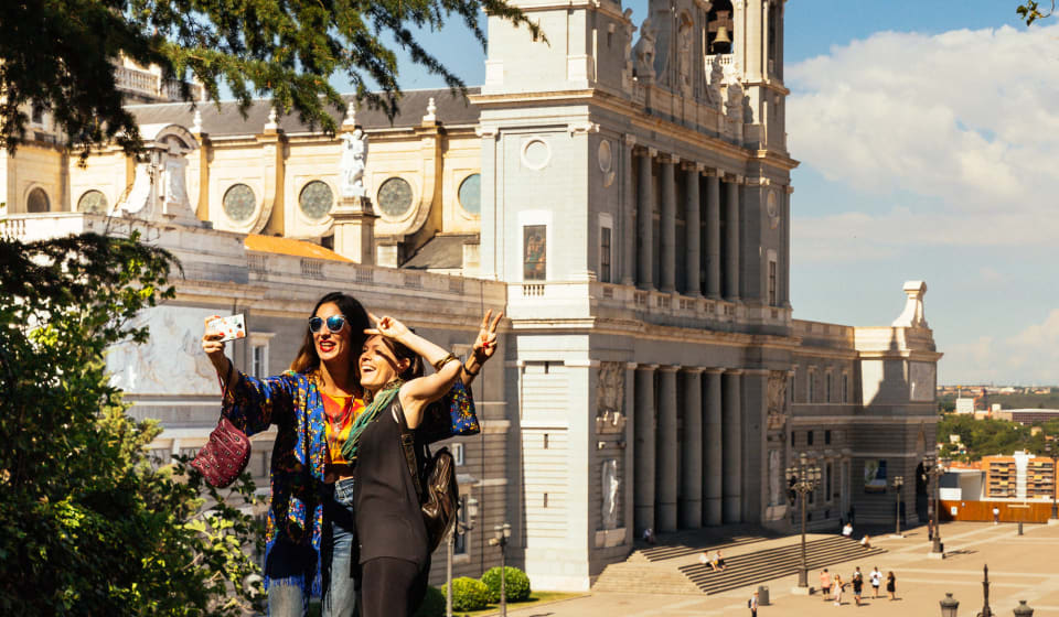 Two tourists making a picture at Catedral de la Almudena in Madrid