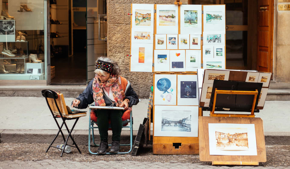 A street artist painting on the streets of Florence