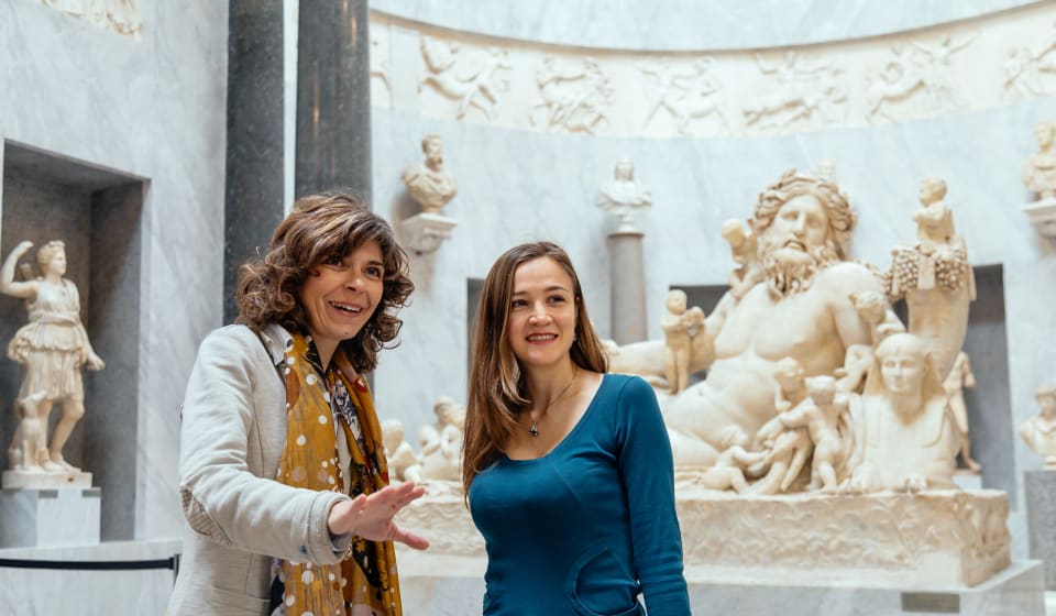 A local guide showing a tourists the inside of the Vatican on a private tour in Rome