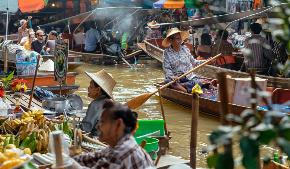 A view on the river near Bangkok with various boats floating next to each other