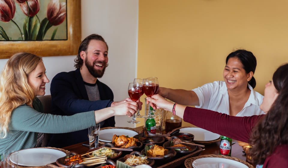 A group of tourists enjoying an Indonesian home dinner in Eindhoven