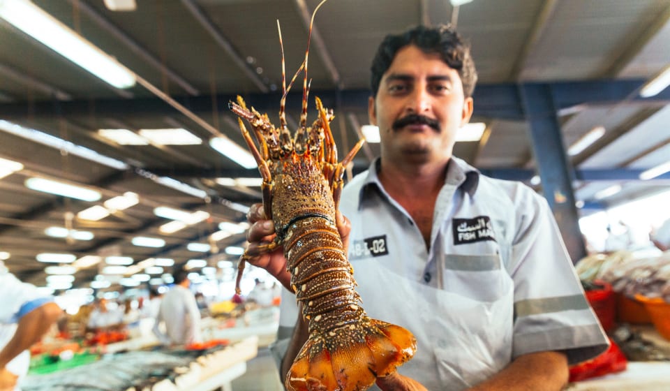 Try the delicious seafood of Sharjah with a local