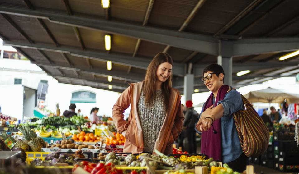 A local guide showing local product to a tourist a Mercato Centrale in Florence