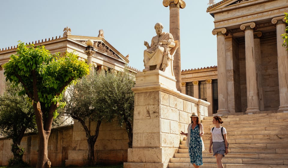 A local guide with a tourists walking within temples in Athens