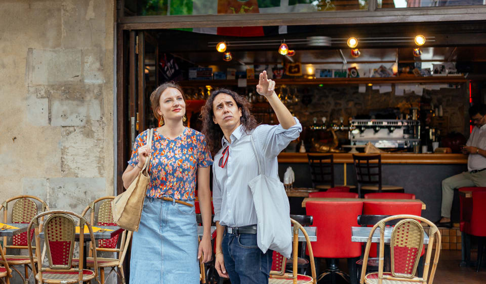 A local guide with a tourist in Le Marais showing this district in Paris
