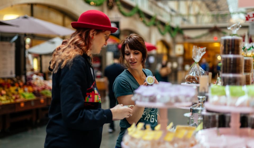 A local guide showing a local product at a framers market in San Francisco
