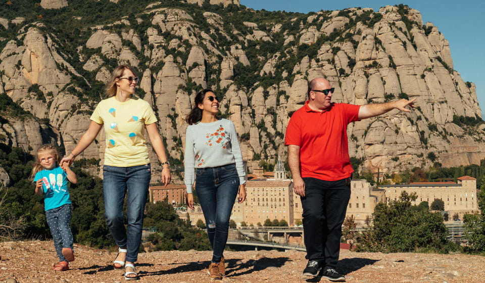 A small group of tourists with Montserrat in the background