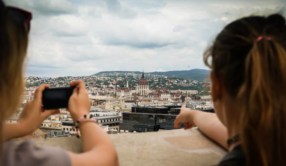 Two tourists making a picture of the Hungarian Parliament from a high view point