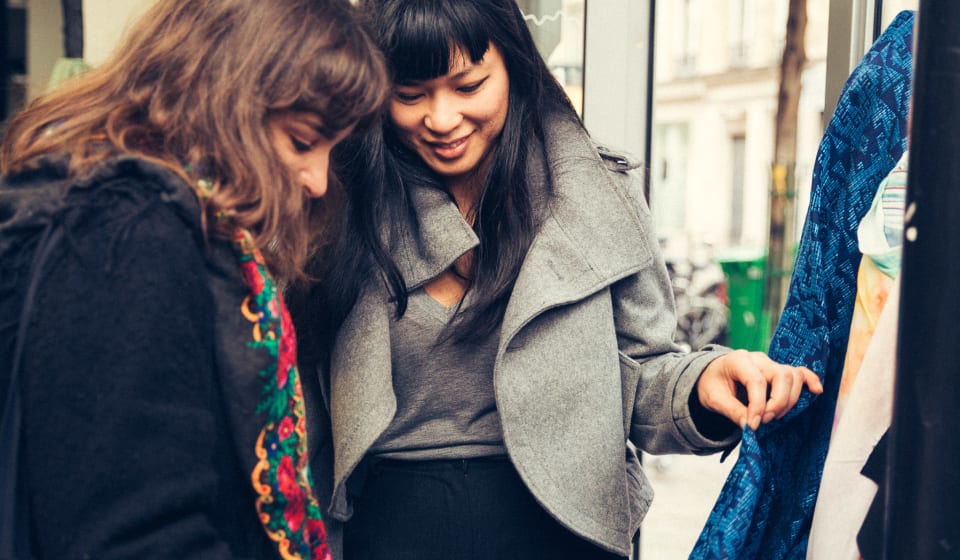 Two people looking a jacket in a shop