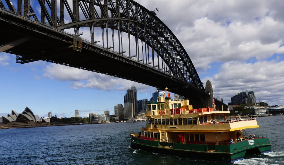 Colorful boat going under the Harbor Bridge