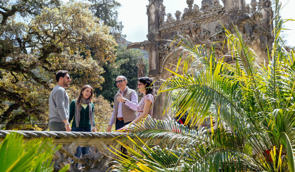 A local with a group of tourist telling a story near a gate in Sintra