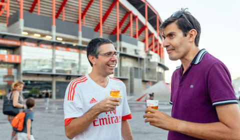 Two football supports of Benfica having a beer in front of Estádio da Luz in Lisbon