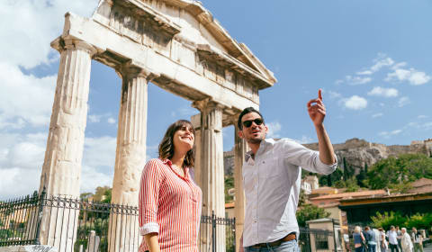 A local guide with a tourists standing at the Acropolis in Athens