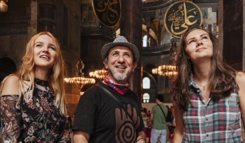 A local guide with two tourists in Hagia Sofia in Istanbul