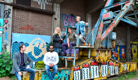 A group of locals sitting at NDSM surrounded graffiti in Amsterdam