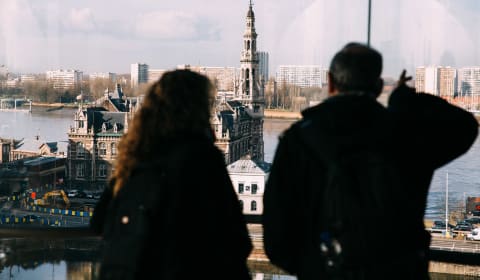 Two people looking through a window to an old building in Antwerp