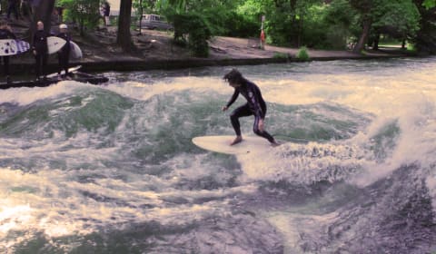 Guy surfing on the Eisbach river