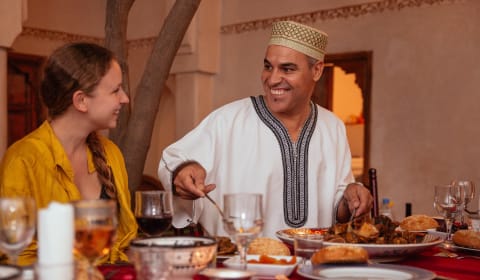 A man and lady sharing food in a a house in Marrakech