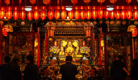 The inside of the Long Shan Temple with all the lampoons lit