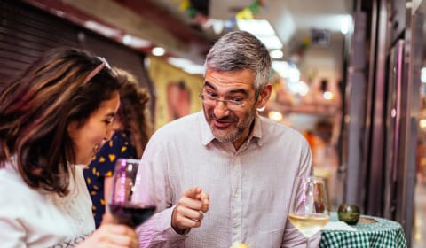 A local guide with a tourist showing tapas at a market hall in Madrid