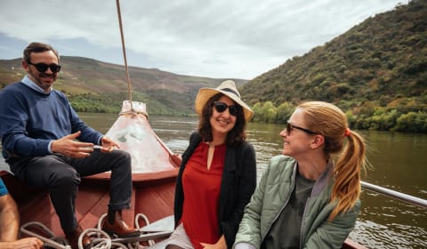 A group of tourists with a local guide on a boat on the Duoro River near Porto