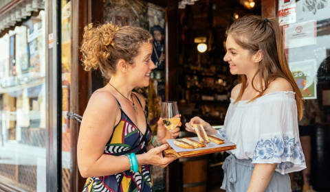 A local sharing local tastings in Malaga with a tourist