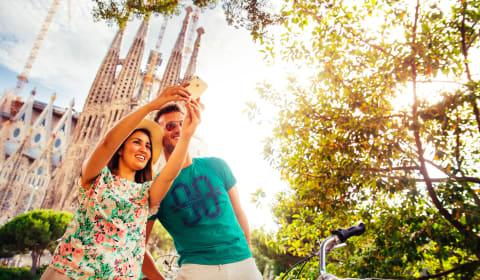 A local guide and a tourist taking a selfie at Gaudi's Basilica Sagrada Familia in Barcelona