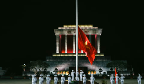 Vietnamese officials are raising the flag at the Ba Dinh Square in Hanoi