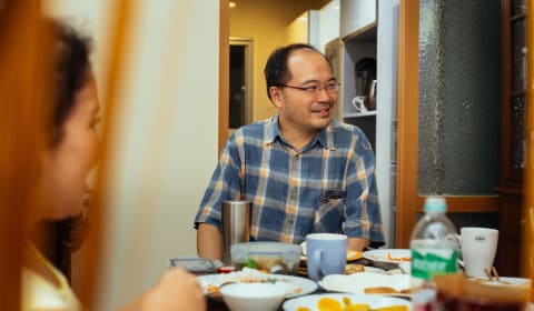 A local guide at the table with Taiwanese food on the table