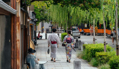 Two Geisha women walking over the streets in Gion