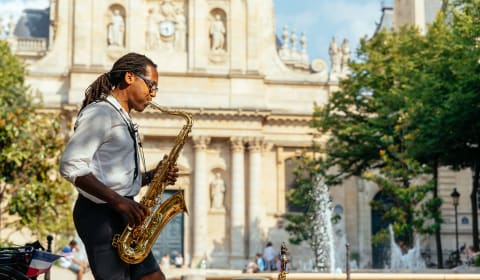 A man playing the saxophone in the Latin Quarter in Paris