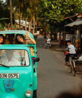 A Tuk tuk with some tourists on board